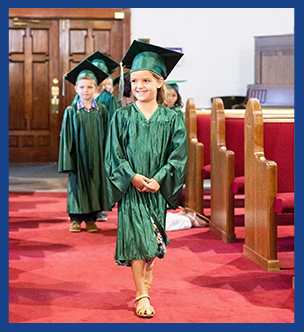 Happy graduate walking down the aisle during K-5 graduation